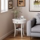 Round white end table with open drawer and shelf, perfect for storage in any living room or bedroom setting.